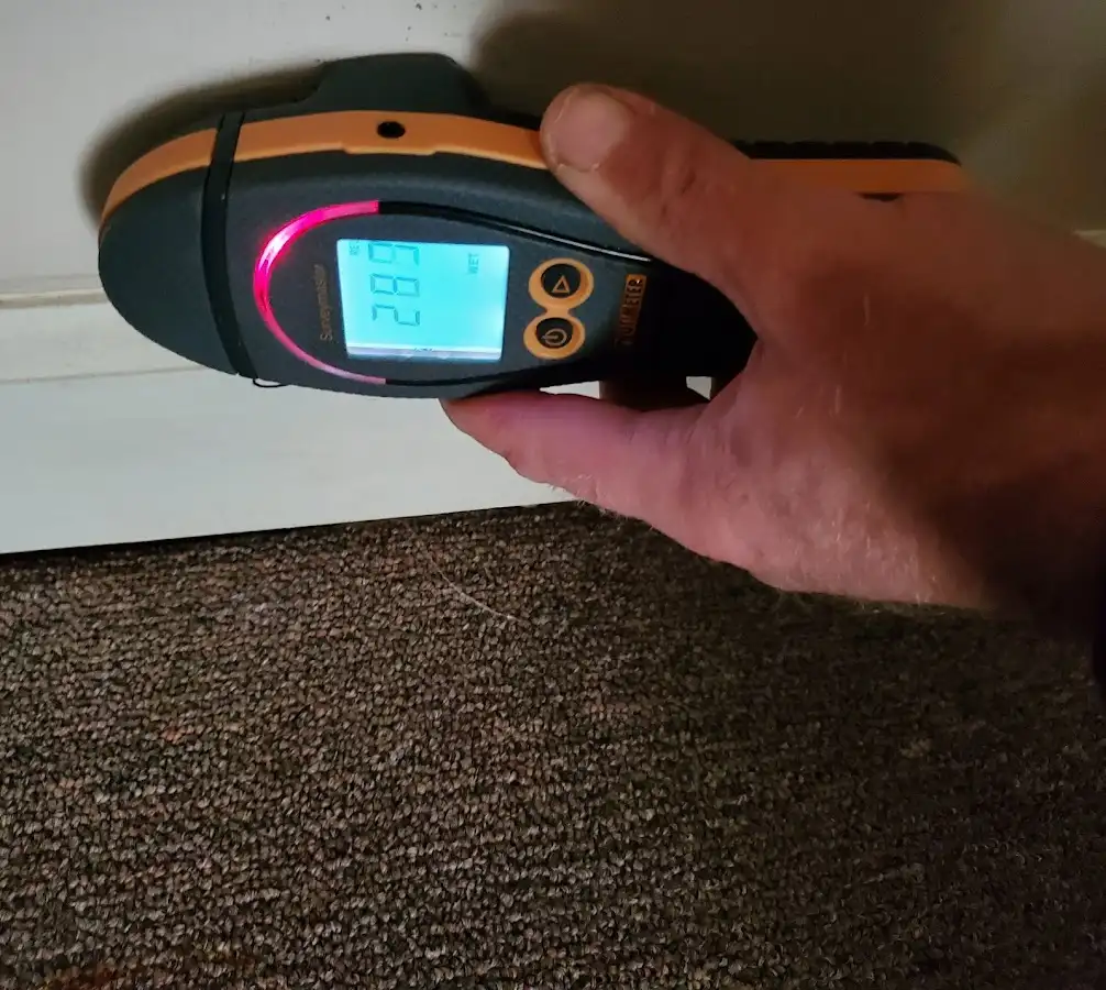 Moisture detection at baseboard during Storm Damage Restoration in La Follette
